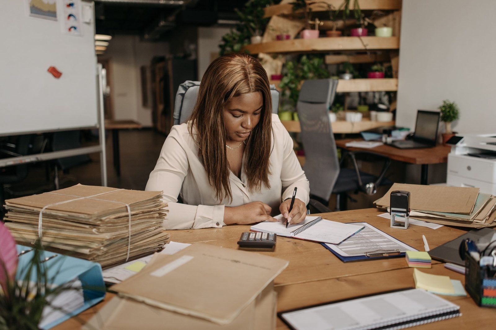 An administrator writing at her desk