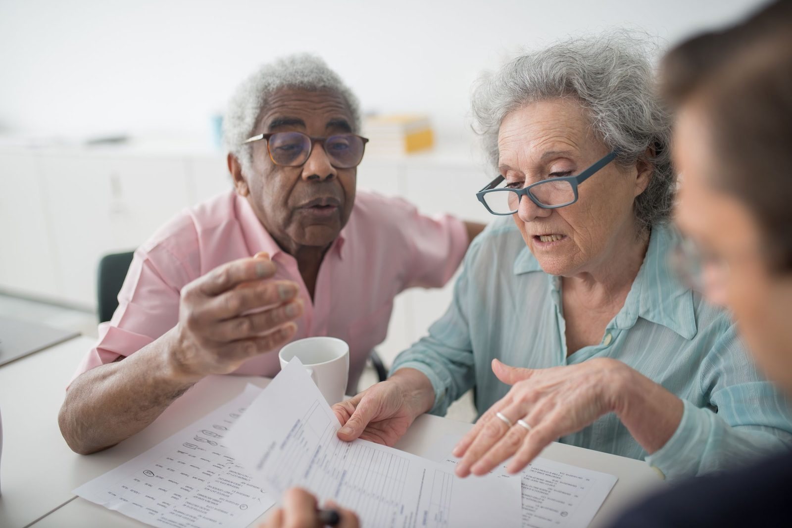 An older couple going through papers with their adviser