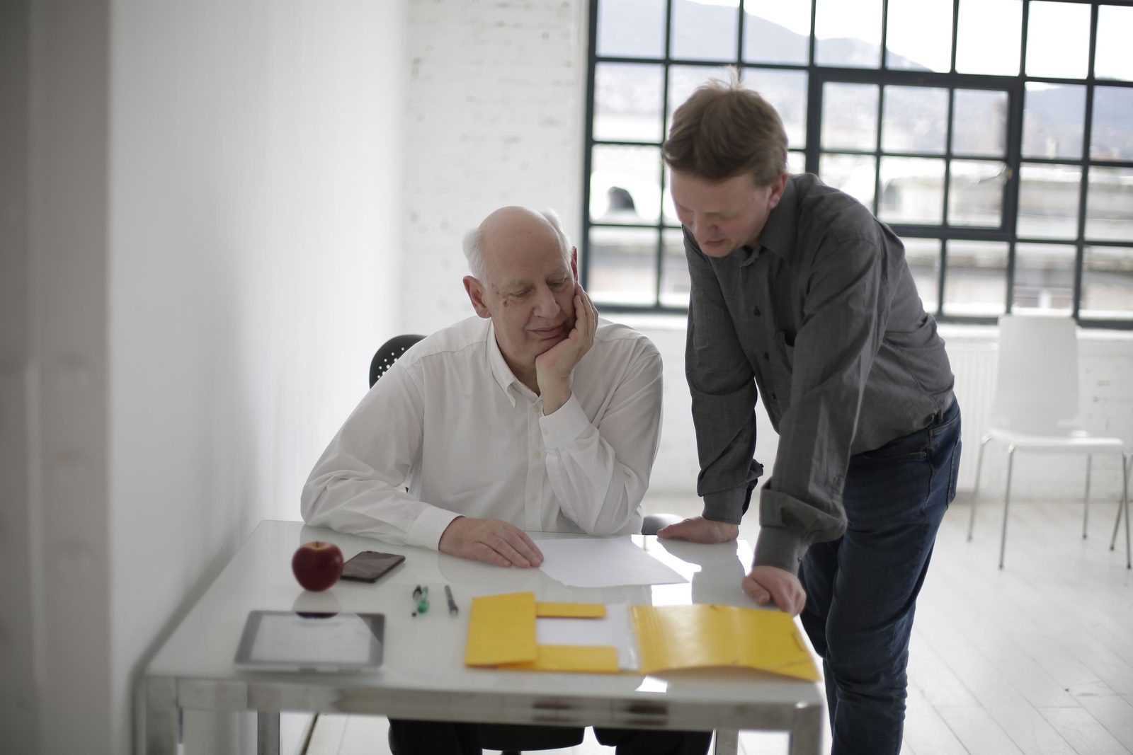 A junior colleague taking a principal through a client file