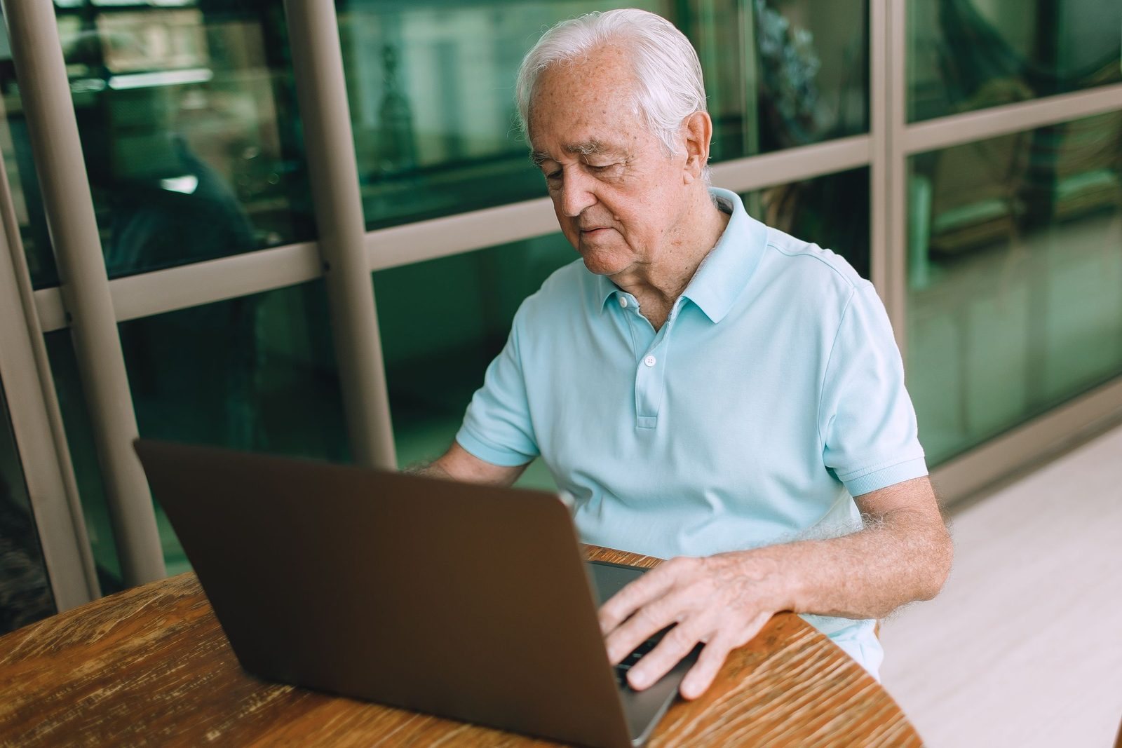 An adviser at his laptop by a window